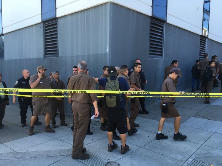 UPS workers gather outside after a shooting at a UPS warehouse and customer service center in San Francisco on Wednesday.