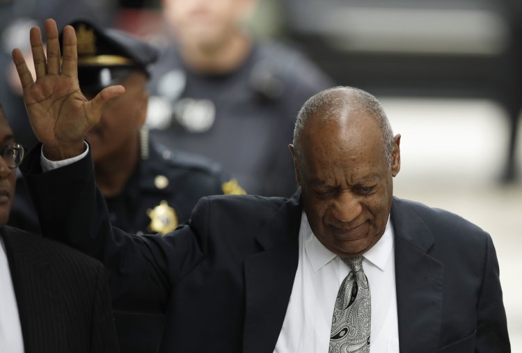 Bill Cosby waves as he arrives at the Montgomery County Courthouse for his sexual assault trial on Saturday in Norristown, Pa. 