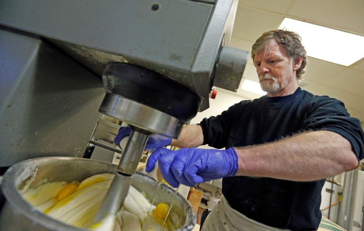 Masterpiece Cakeshop owner Jack Phillips cracks eggs into a mixer in his store in Lakewood, Colo., in this 2014 photo. Supreme Court justices will consider whether he  can refuse to make a wedding cake for a gay couple. 