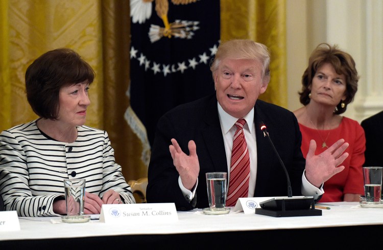 President Trump speaks as he meets with Republican senators on health care at the White House on Tuesday. Sen. Susan Collins, R-Maine, left, and Sen. Lisa Murkowski, R-Alaska, right, listen. Collins opposes the health care bill proposed by Senate Republican leaders.