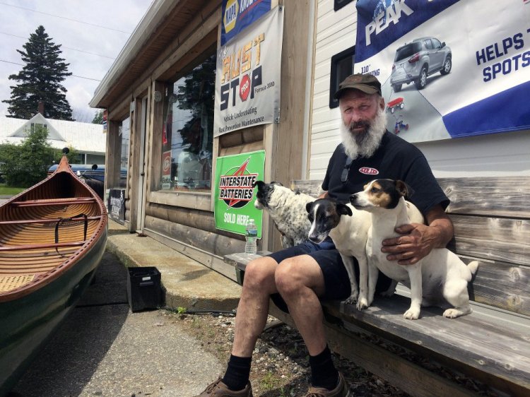 Domenic Pono sits with his three Jack Russell terriers outside his store, Dom's Auto and Jeep Repair, on Main Street in Rangeley. He's hopeful the prospective new owners of Saddleback ski area, the Majella Group, will keep the character of the mountain if it's expanded to a four-season resort.