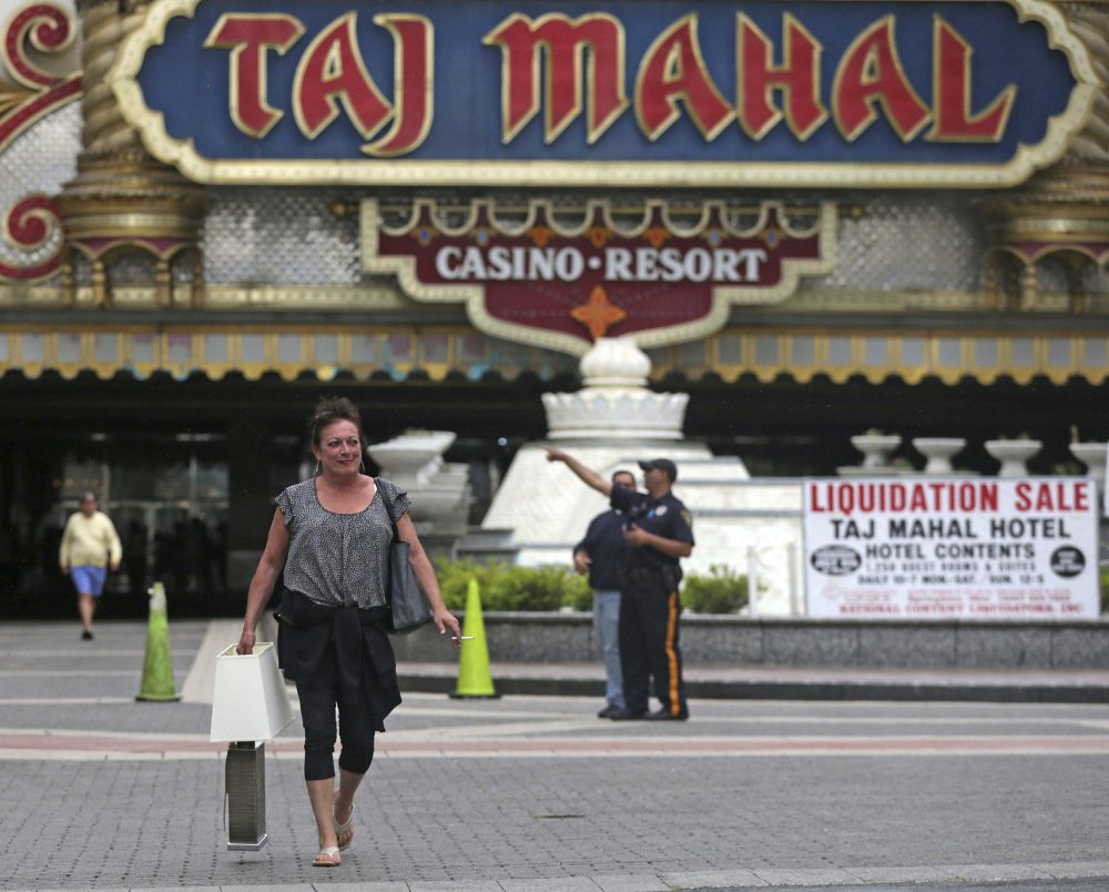 Patty Johnston of Atlantic City, N.J., leaves the Taj Mahal Thursday after buying a ceramic lamp and a flat-screen television. Hundreds of people swarmed the lobby looking for deals on fancy stuff.