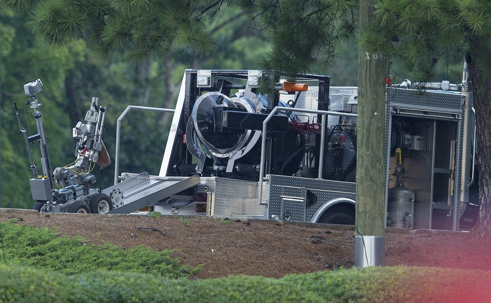 A police robot carries a device into a bomb squad vehicle in Marietta on Friday. A man who claimed to have a bomb forced a standoff until he was killed in an officer involved shooting.