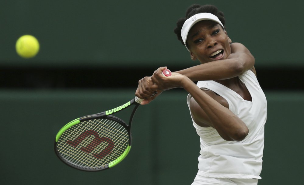 Venus Williams returns to Garbine Muguruza during the women's final match on day 12 at Wimbledon in London on Saturday. Muguruza defeated Williams, 7-5, 6-0.