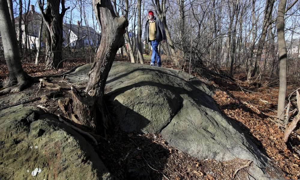 Salem State University history professor Emerson Baker walks through an area known as Proctor's Ledge in 2016. He and a team of researchers concluded it is the exact site where innocent people were hanged during the 1692 witch trials in Salem, Mass.
