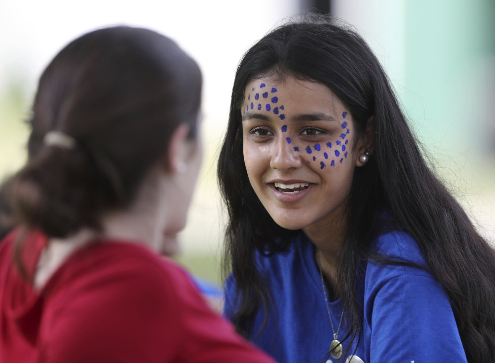 A camper from Pakistan, right, talks with an American at the Seeds of Peace camp in Otisfield.