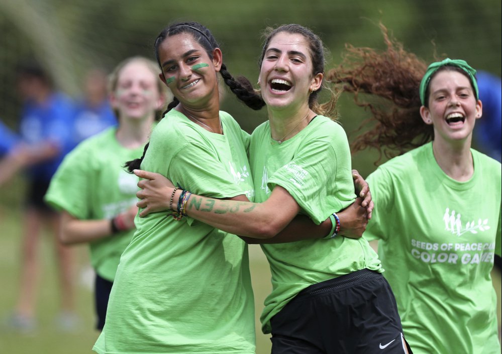 U.S. and U.K. campers celebrate a soccer goal at the Seeds of Peace camp.