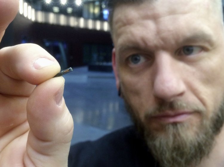 Jowan Osterlund of Biohax Sweden holds a microchip implant similar to ones given to workers there earlier this year. Three Square Market in River Falls, Wis., is partnering with Biohax International in offering to microchip Three Square workers.