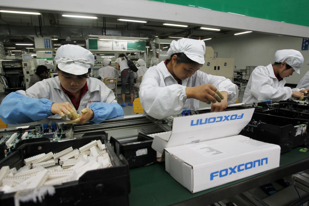 Foxconn staff on the production line at its complex in the Chinese city of Shenzhen. Foxconn said its $10 billion Wisconsin factory will eventually employ 13,000 workers.