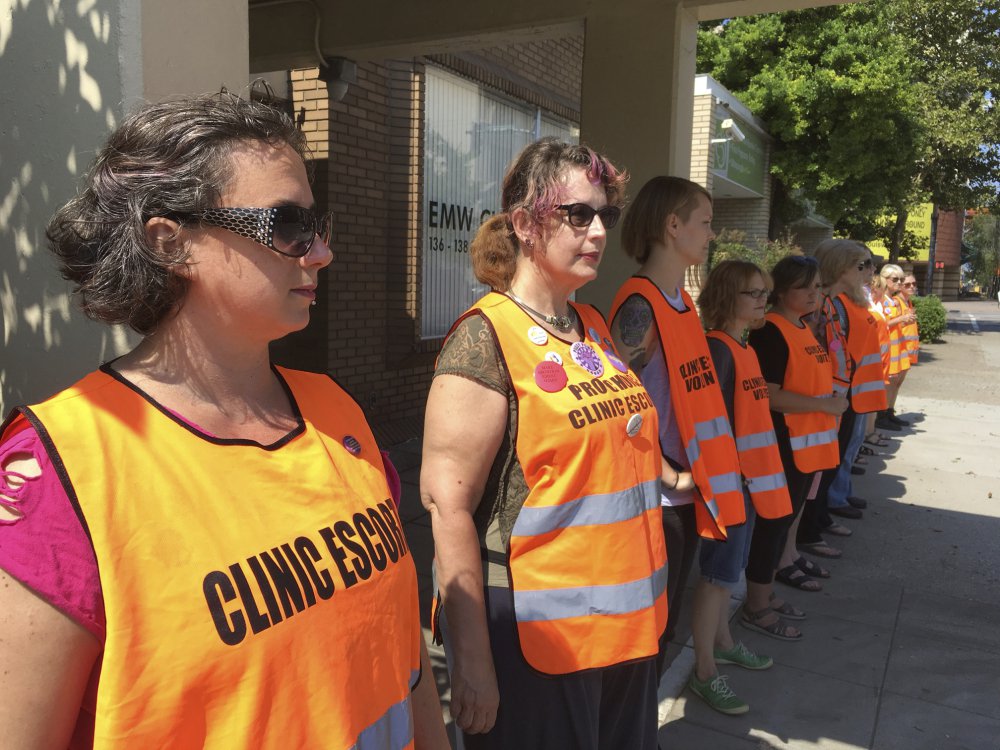 Escort volunteers line up outside the EMW Women's Surgical Center in Louisville, Ky. 