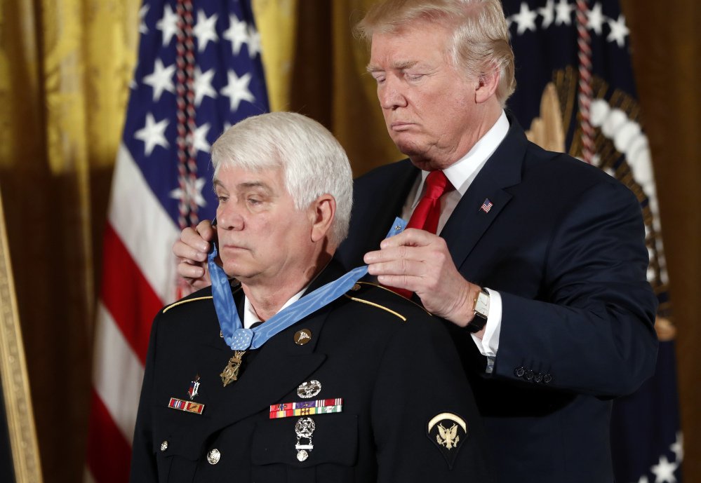 President Trump bestows the nation's highest military award, the Medal of Honor, on retired Army medic James McCloughan during a ceremony at the White House on Monday.