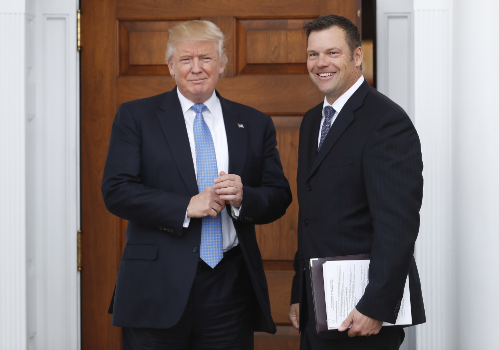 Kansas Secretary of State Kris Kobach, right, meets with then-President-elect Donald Trump in November. Kobach is the source for Trump's belief that fraudulent voting by noncitizens cost him the popular vote.
