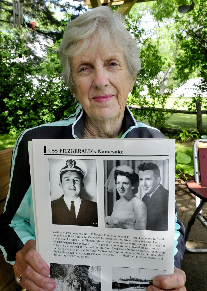 Evalyn Bowman of Skowhegan on Tuesday holds photos of her friend William Fitzgerald, who she attended school with in Vermont, and his wife, Betty. Bill Fitzgerald died during the Vietnam War. The Arleigh-Burke class destroyer USS Fitzgerald, named after him, was seriously damaged in a collision with a cargo ship near Japan earlier this month.
