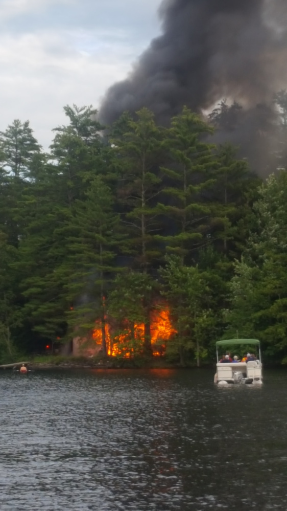 Fire destroys a guest cottage Tuesday on the the west shore of Maranacook Lake in Readfield. Fire officials saif Wednesday the blaze was an accident.