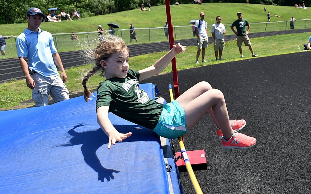 Winthrop's Gwen Lewis competes in the high jump during a youth summer track meet Thursday at Winslow High School.