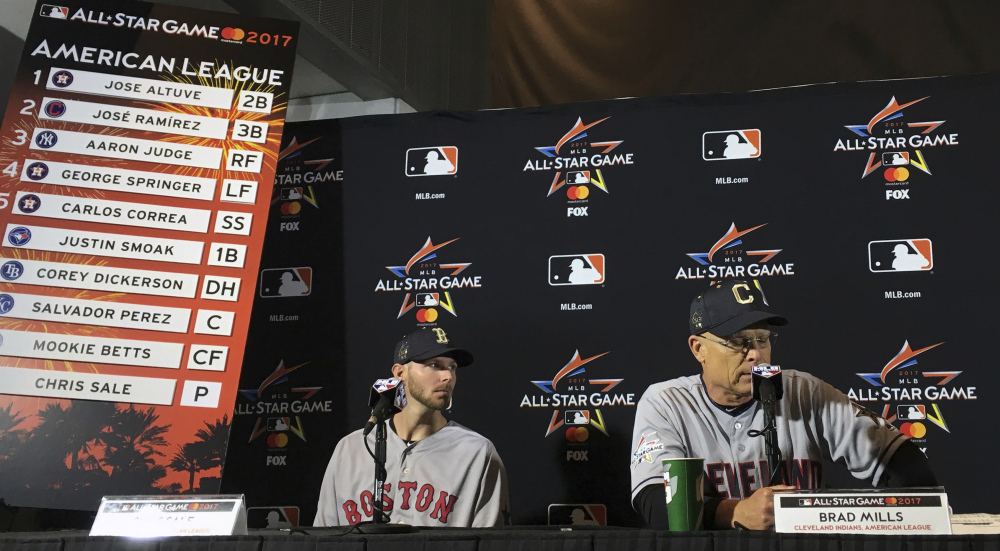 American League All-Star Game starting pitcher Chris Sale, left, looks on as AL manager Brad Mills speaks during a press conference for the All-Star game in Miami on Monday.