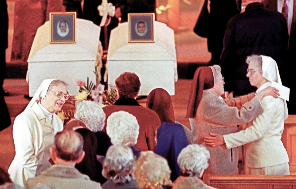 Superior General Sister Mary Catherine Perko, left, and Provincial Superior Sister Catherine Marie Caron greet mourners on Jan. 31, 1996, at the wake held for slain Sister Edna Mary Cardozo, in the left casket, and Sister Marie Julien Fortin. Mark A. Bechard, who killed the two women, died Sunday at a long-term care facility in Freeport.