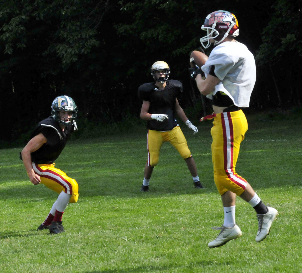 Staff photo by David Leaming
East receiver Josh Buker makes a catch during Lobster Bowl practice Tuesday at Dover-Foxcroft.
