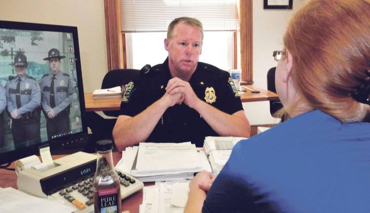 Skowhegan police Officer David Bucknam speaks with Town Manager Christine Armand on Tuesday in her office. Bucknam has been appointed the town's new police chief.