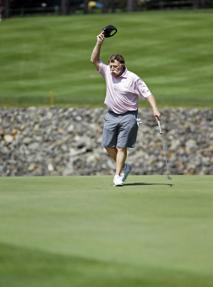 Mark Plummer waves to a small crowd after making his final putt during the opening day of the 98th Maine Amateur at Brunswick Golf Club.