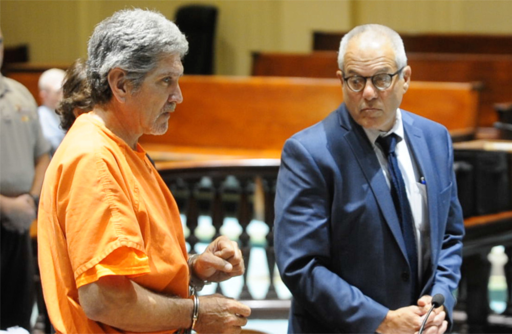 James Sweeney, left, replies "yes" through a sign-language interpreter to a question from Justice William Stokes on Thursday as he makes an initial appearance on a murder charge in Androscoggin Superior Court in Auburn. His defense attorney, Walter Hanstein, is at right.