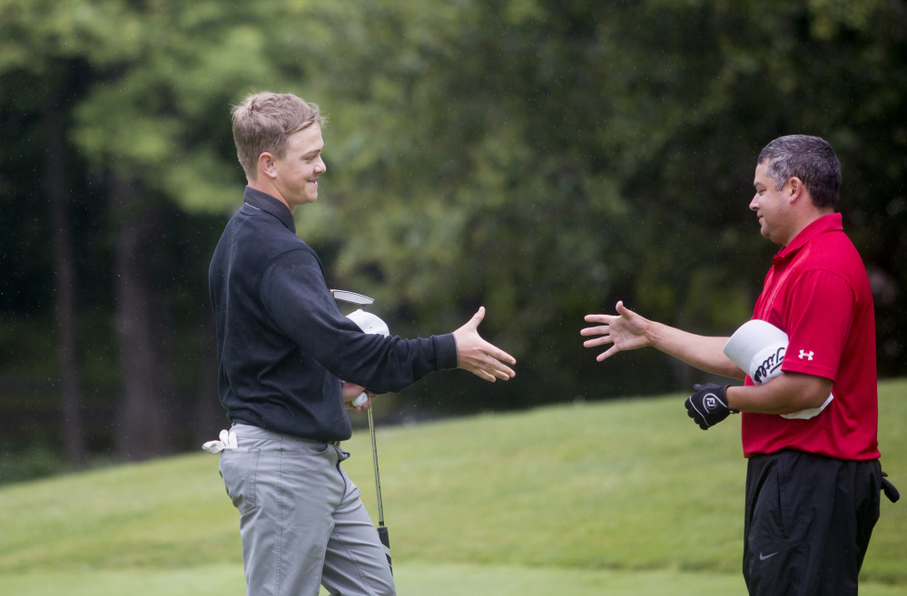 Jack Wyman, left, shakes hands with Joe Alvarez after the final round of the Maine Amateur golf tournament Thursday at the Brunswick Golf Club. Wyman, of South Freeport, who plays out of the Portland Country Club, won the tournament. He is the first left-handed player to ever win in the tournament.