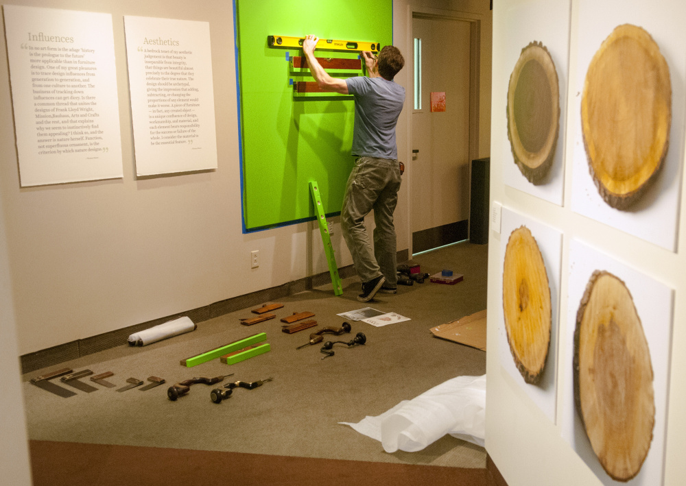 Maine State Museum exhibits preparator Ryan Walker builds shelves for levels and other tools in the entryway to the "Thos. Moser: Legacy in Wood" exhibition under construction Tuesday at the museum in Augusta. The exhibit opens Saturday and runs through Jan. 13, 2018.