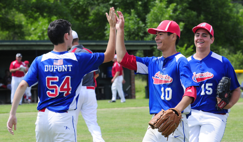 Augusta's Logan Dupont, left, Akira Warren (10) and Luke Anderson celebrate a 5-0 victory over South Portland in a 14U Babe Ruth All-Star game Friday at McGuire Field in Augusta.