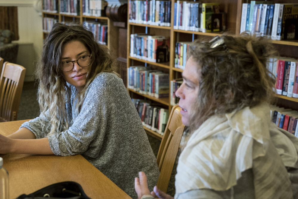 Lana Smithner, left and her mother, Denise Rohdin, both of Waterville, discuss their interest in LumenARRT! at a workshop Saturday at the Waterville Public Library. The activist artistry projected on buildings was on display at the opening night of the Maine International Film Festival.