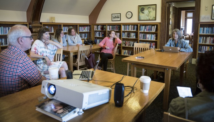 Community members and visitors who were in Waterville for the Maine International Film Festival attend a Saturday workshop at the Waterville Public Library on activist project art known as LumenARRT!.