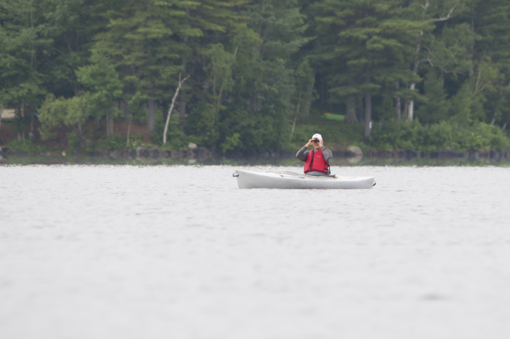 Richard Dillenbeck, of China, searches for loons Saturday from a kayak on China Lake during Maine Audubon's annual loon count Saturday.