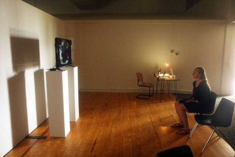 Common Street Arts' intern Alyssa Chesney watches a film by Kerry Laitala on Sunday in Waterville at MIFFONEDGE Volume 5, a part of the Maine International Film Festival, which is billed as a way to explore the intersections of art and film.