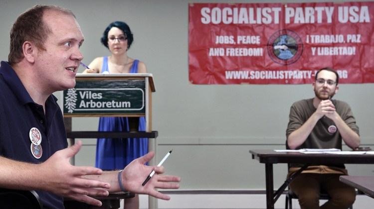 Tom MacMillan, left, Maia Dendinger and Jeremy Claywell on Sunday discuss the platform for the Maine Socialist Party during a meeting in Augusta.