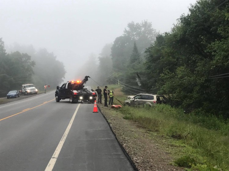 A 2009 Subaru Forester that crashed on Monday into a ditch along U.S. Route 201 in The Forks, breaking a utility pole, is towed. The driver, Jay Borden of New Hampshire, has been charged with operating under the influence.