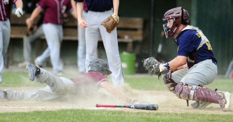 Franklin baserunner Tom Wing slides safely into home to tie a Zone 2 playoff game with Augusta at 2-2 in 4th inning at Morton Field in Augusta.
