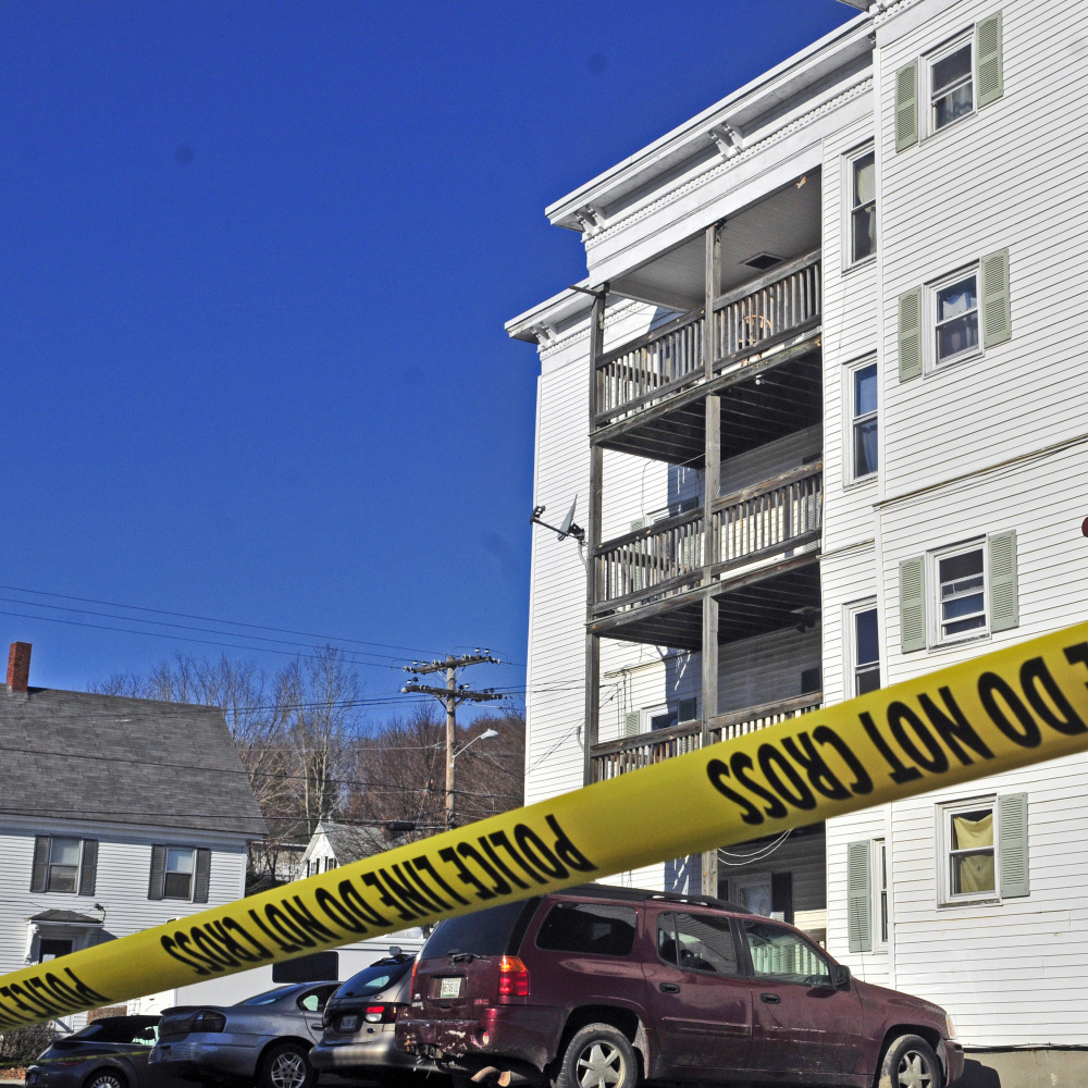 Police tape surrounds a parking lot on Nov. 24, 2015, at 75 Washington St. in Augusta, the day after Joseph Marceau, 31, was beaten to death in an apartment there.