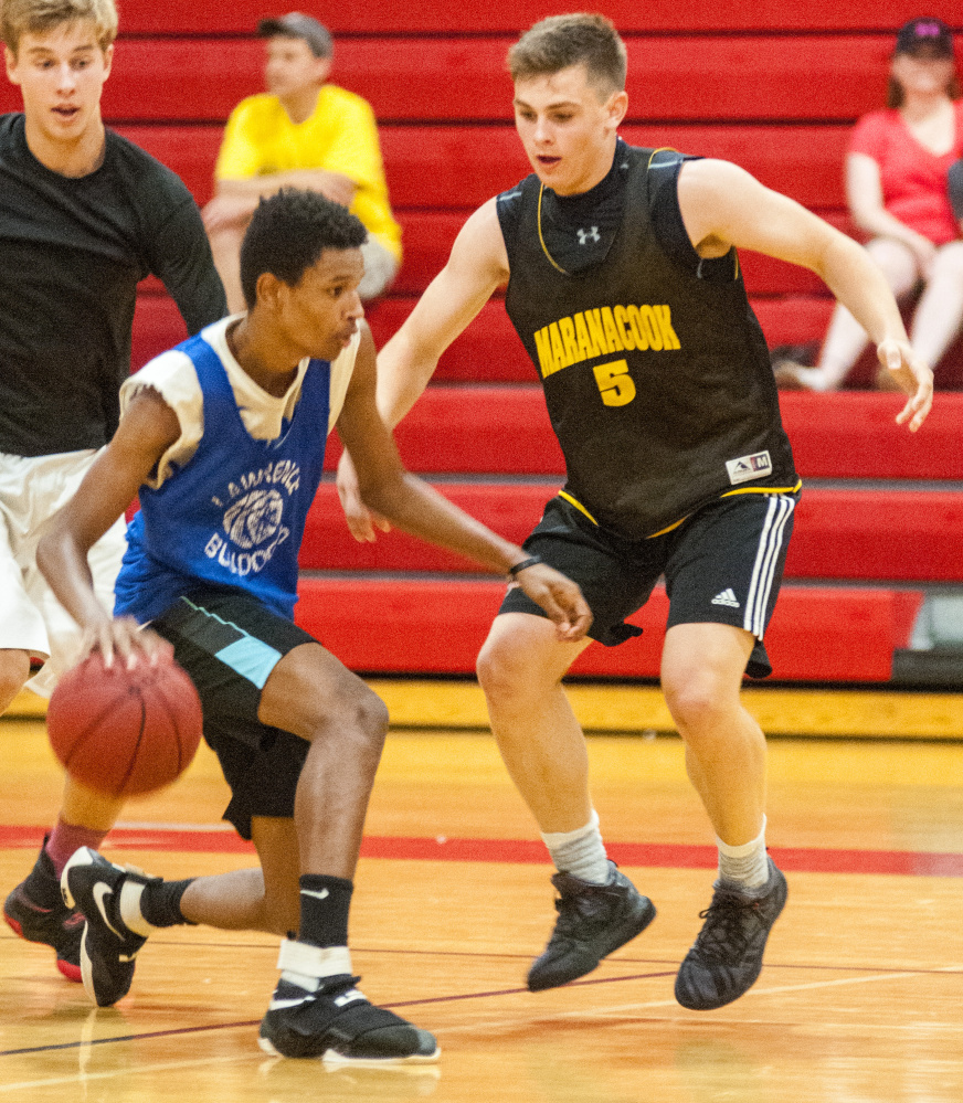 Lawrence's Raheem Goodwin, bottom left, tries to get around Marancook's Jake Patterson during a summer league game Wednesday at Cony High School in Augusta.