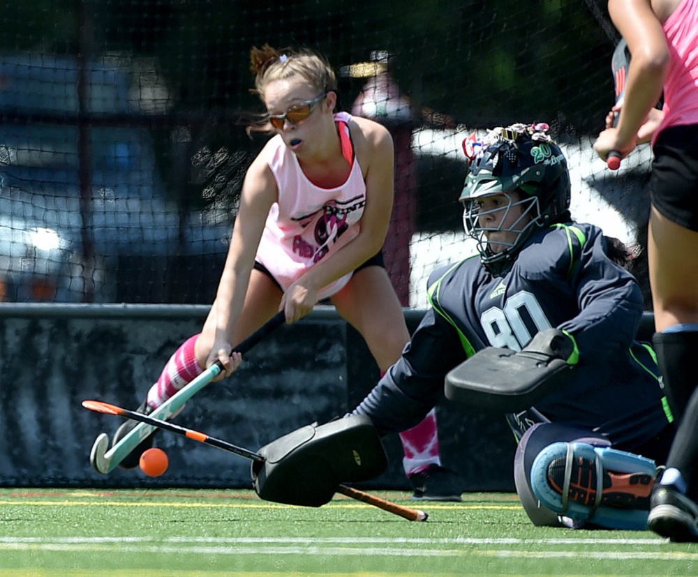 Staff photo by Michael G. Seamans 
 Spruce Mountain goalie Melissa Bamford (80) tries to make a save on a Skowhegan goal during the 7th annual Battle for Breast Cancer field hockey tournament Saturday at Thomas College in Waterville.