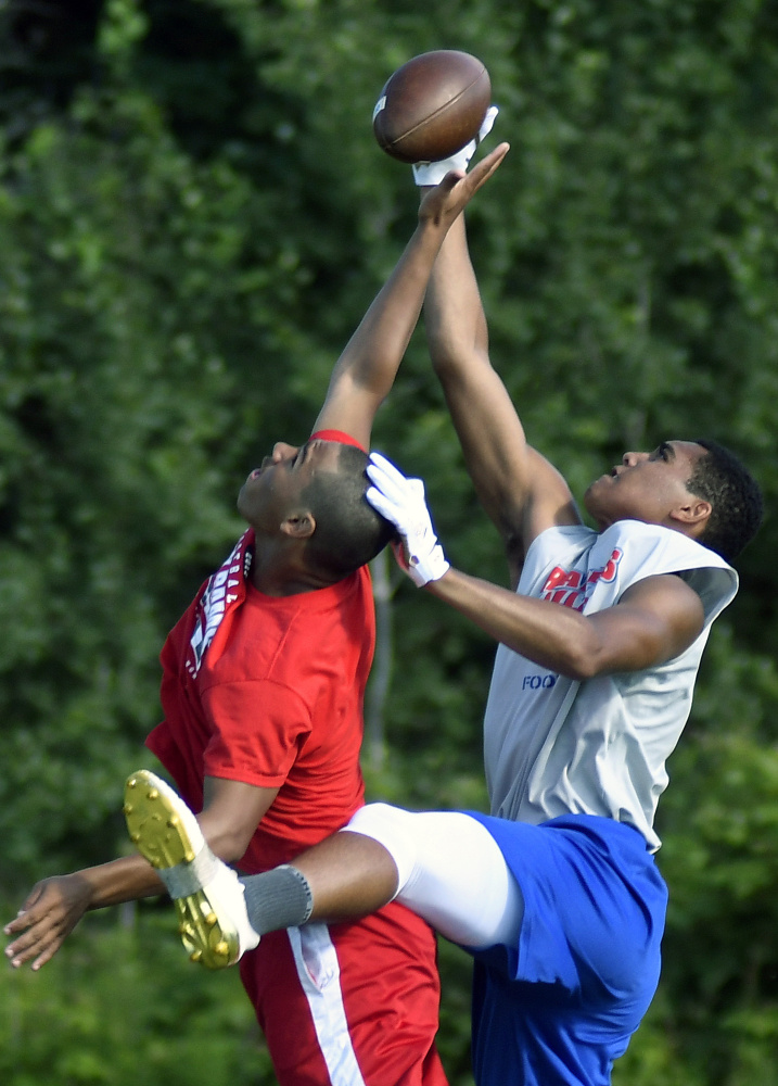 Oak Hill's Darryn Bailey, right, intercepts a pass intended for Cony's Ashton Cunningham during the 7x7 football tournament Sunday in Turner.