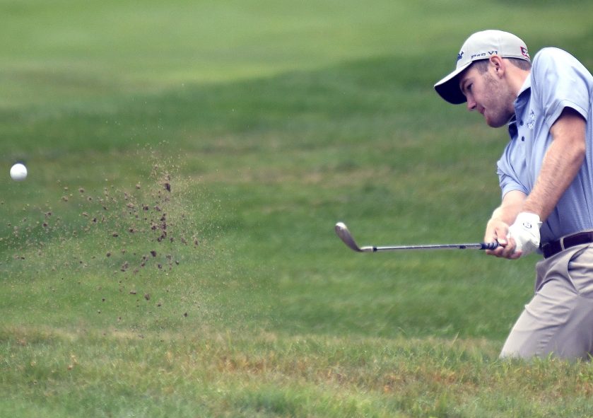 Sam Grindle, of Deer Isle, works his way out of a bunker during the first round of the Maine Open in Manchester on Monday.