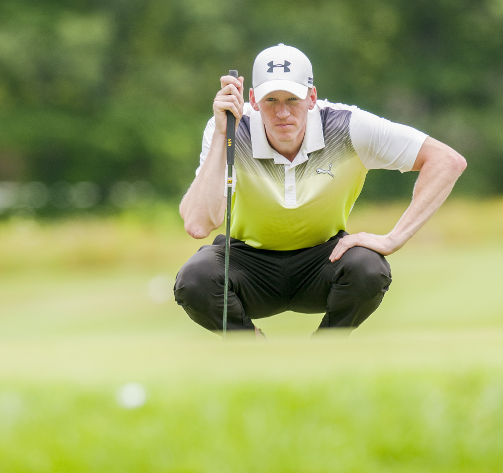 Staff photo by Joe Phelan 
 Jason Thresher squats down to line up a shot during the final round of the Charlie's Maine Open on Tuesday at the Augusta Country Club in Manchester.
