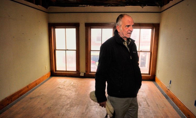 Terry Berry, a Gardiner city councilor who hopes to use federal money to improve the outside of his building on Water Street, looks around inside the building in March during a tour.