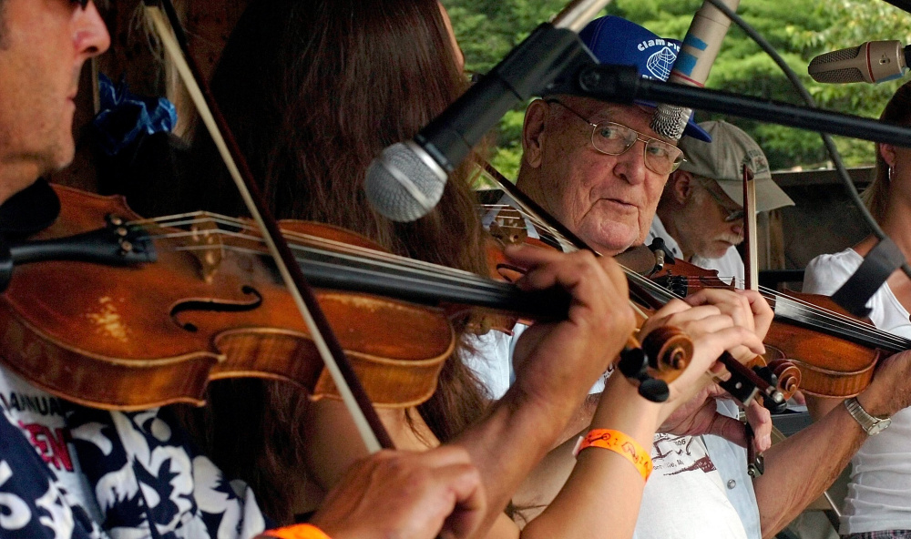 SEASONED FIDDLER: Fiddle player Lucien Mathieu joined other music judges on stage before competition during the East Benton Fiddlers Convention at the Littlefield family farm on Sunday. Music lovers filled the field to listen to fiddlers play in junior and adult divisions, dance and picnic on a hot summer day.