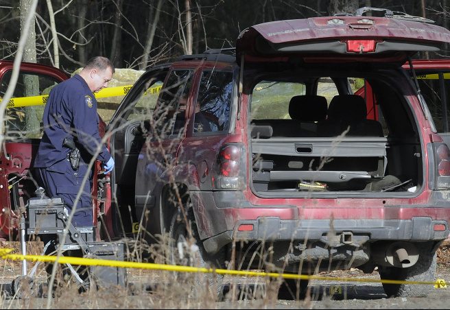 Maine State Police evidence technicians examine the SUV containing two bodies discovered early on Dec. 25, 2015, on Sanford Road in Manchester. The bodies were those of Eric Williams and Bonnie Royer, who lived nearby in Augusta, and who were shot to death. David Marble Jr. is charged in connection with the slayings.