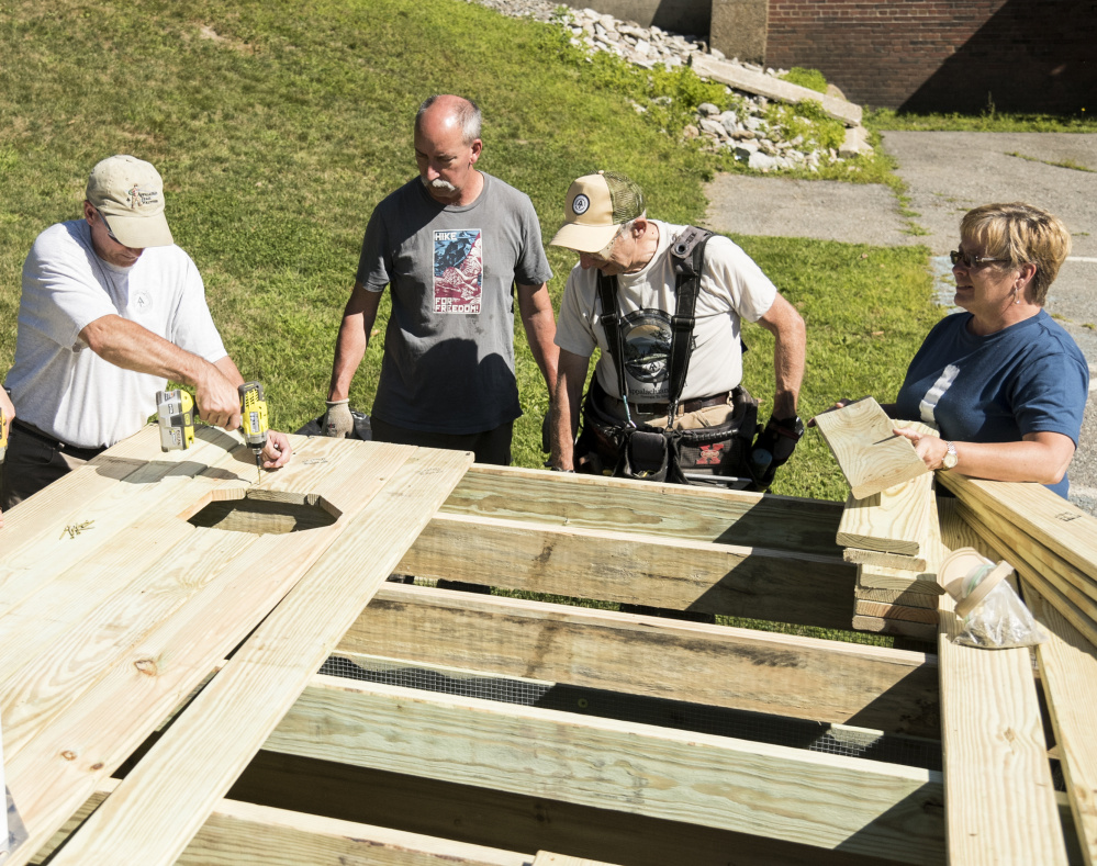 Members of the Maine Appalachian Trail Club build a demonstration privy in advance of the groups' conference at Colby College in Waterville. From left are: Doug Dolan, of Hollis, Richard Gower, of Richmond, Dana Humphrey, of Palmyra, and conference co-chairwoman Sherri Langlais.