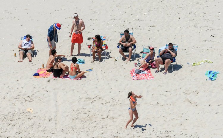 New Jersey Gov. Chris Christie, right, uses the beach with his family and friends at the governor's summer house at Island Beach State Park in New Jersey on Sunday. Christie is defending his use of the beach, closed to the public during New Jersey's government shutdown, saying he had previously announced his vacation plans and the media had simply "caught a politician keeping his word."