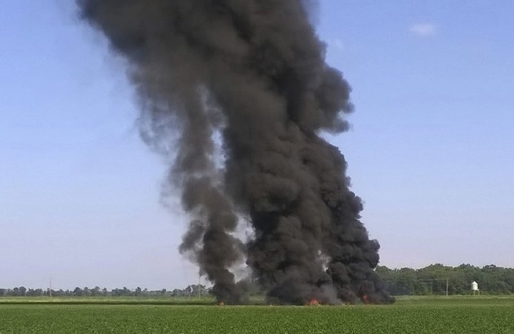Smoke and flames rise into the air after a KC-130 fuel tanker crashed in a field near Itta Bena, Miss., Monday. 