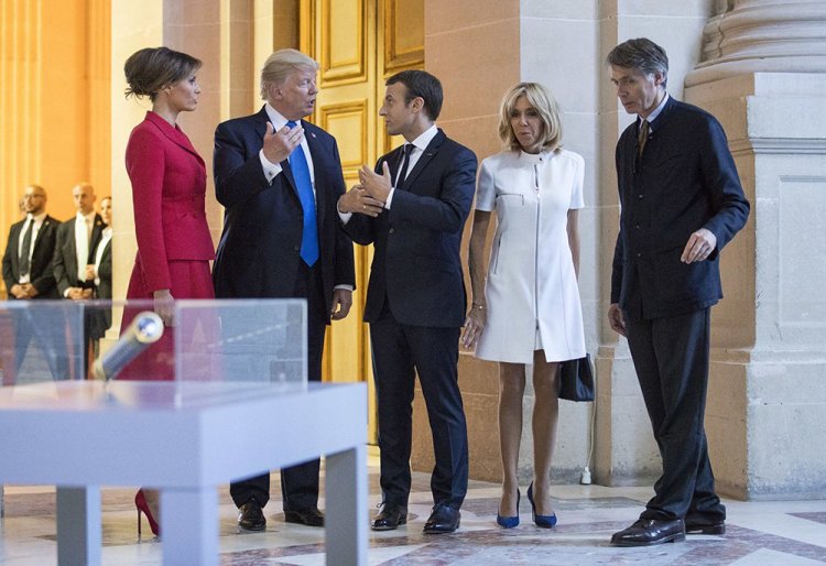 President Trump, Melania Trump, French President Emmanuel Macron and his wife Brigitte Macron tour Marechal Foch's Tomb with David Guillet, director of the Army Museum, at Les Invalides in Paris on Thursday.
