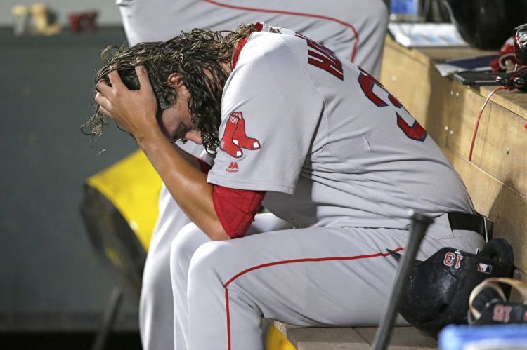 Red Sox pitcher Heath Hembree sits in the dugout after being pulled during the 7th inning of Tuesday night's game against the Seattle Mariners.