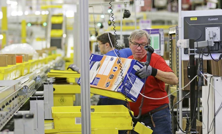 An Amazon employee processes orders at the company's fulfillment center in DuPont, Wash. Its Jobs Day on Aug. 2 will give potential employees a chance to see what it’s like to work at one of 10 fulfillment centers nationwide.